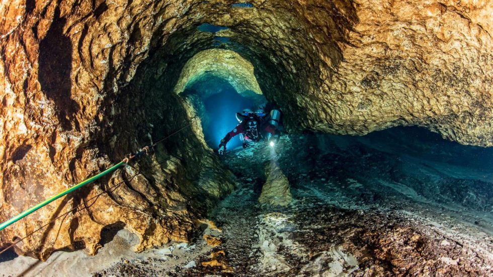 A scuba diver explores an underwater cave at Cow Springs in Suwannee County, Florida.