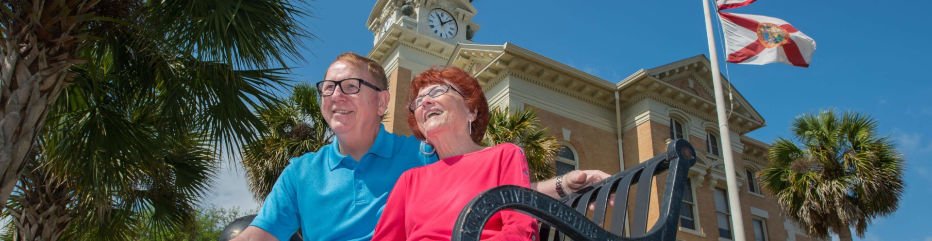 Couple sitting on bench in front of Suwannee County Courthouse