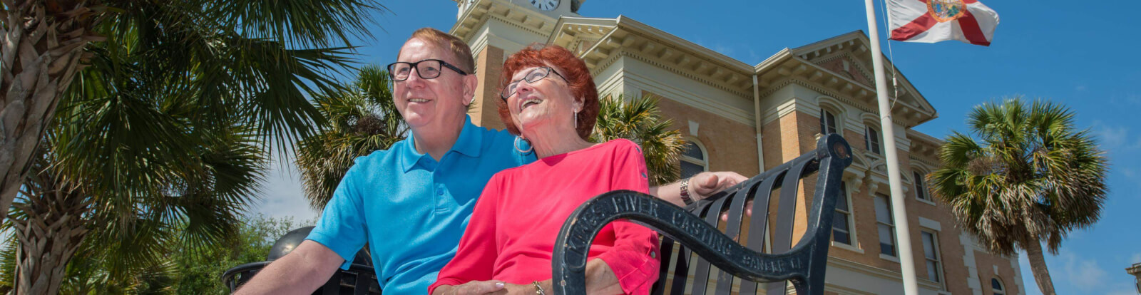 Courthouse with couple sitting on a bench in front