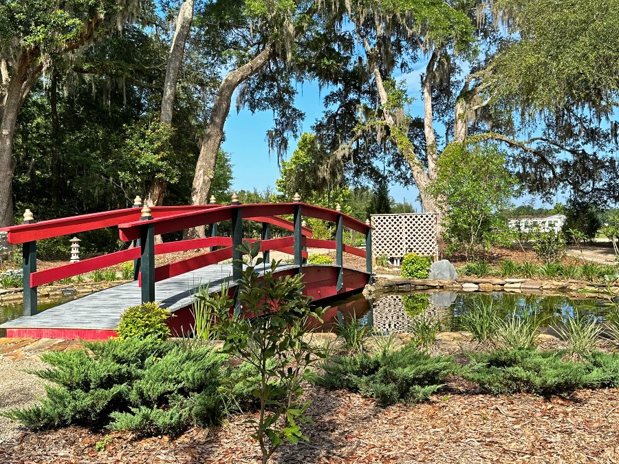 a bridge over a pond at hearthstone gardens