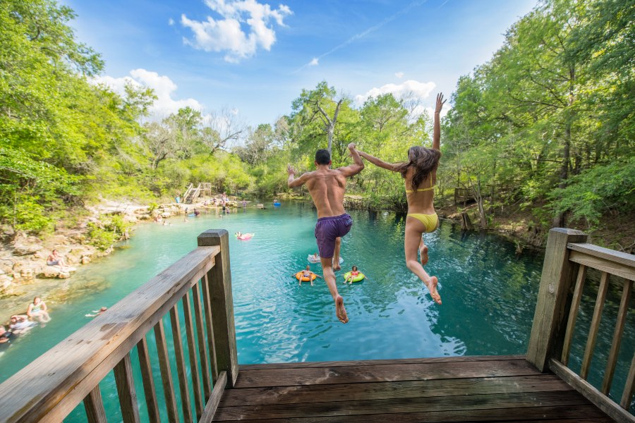 A couple jumps off the diving platform at Royal Springs