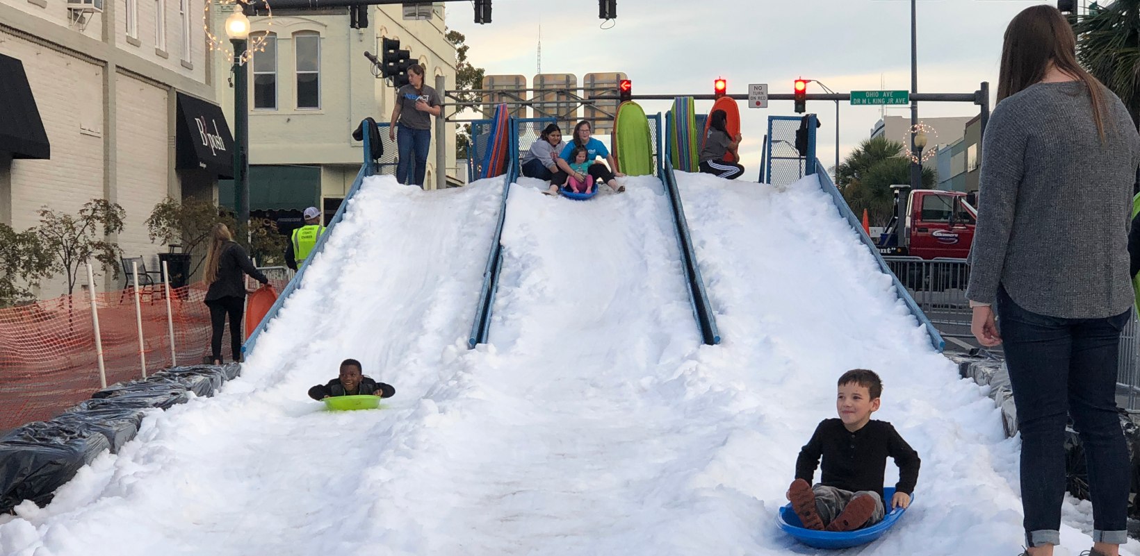 Kids go down a snow slide