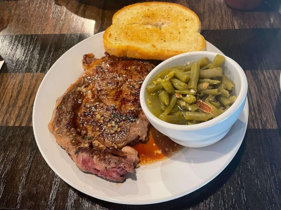 A hearty helping of toast, green beans, and steak fill a plate at The Gathering in Branford, FL.