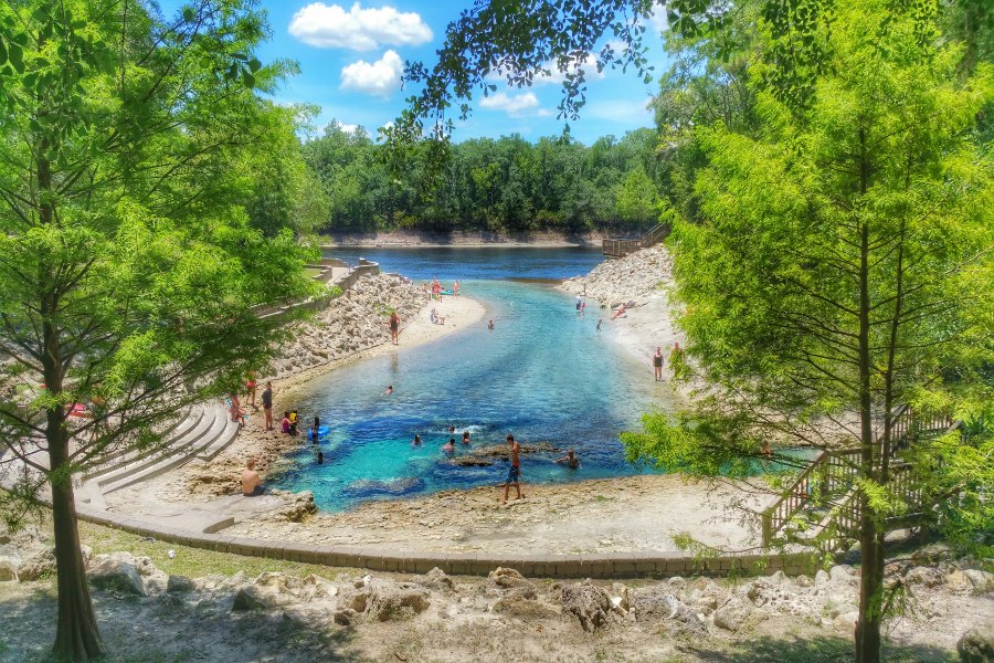 People gather around a bright blue and clear natural spring outside of Live Oak, Fl. 