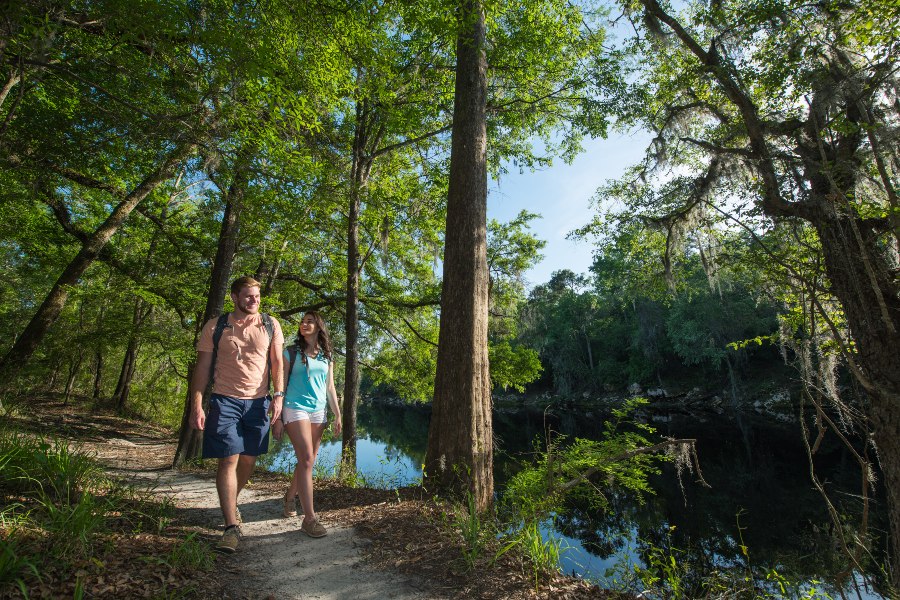 A couple strolls along a wooded path in Suwannee River State Park in Florida.