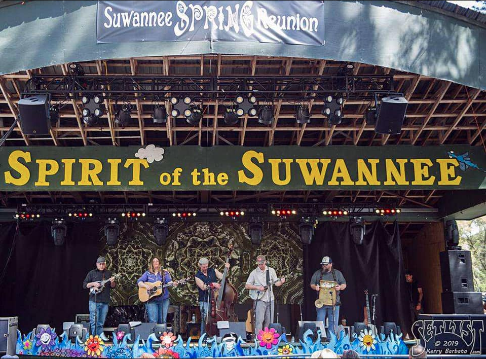 Five musicians perform onstage for a crowd of festival-goers at Suwannee Spring Reunion festival held at Spirit of Suwannee Music Park.