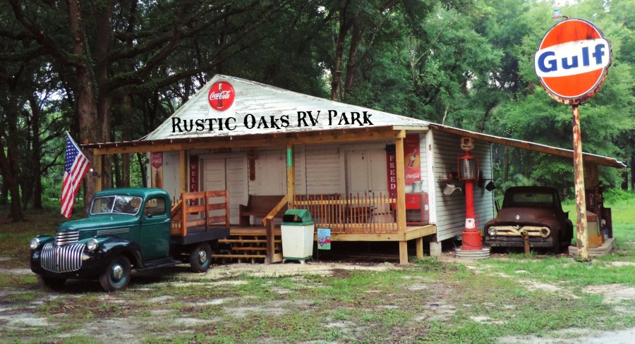 Vintage trucks and old-timey Americana signs surround the outside of the entrance to the Rustic Oaks RV Park, just minutes from Ichetucknee Springs in O'brien, Florida.