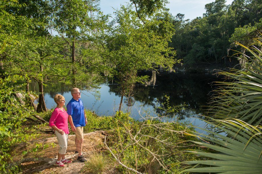 A couple stands on the banks of Suwannee River in Suwannee River State Park.