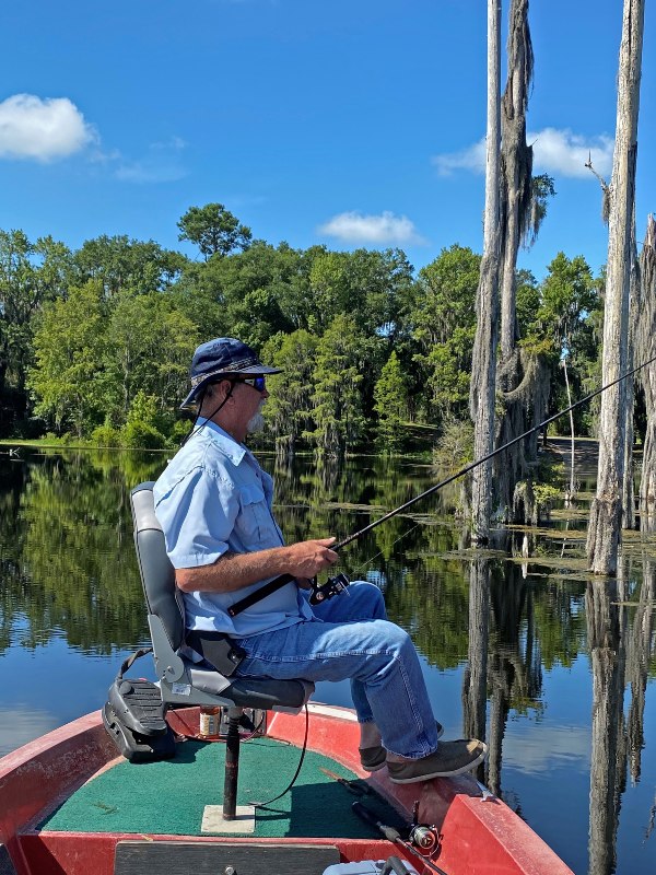 A Suwannee County angler sits at the nose of his boat waiting for a fish to bite on the Suwannee River.