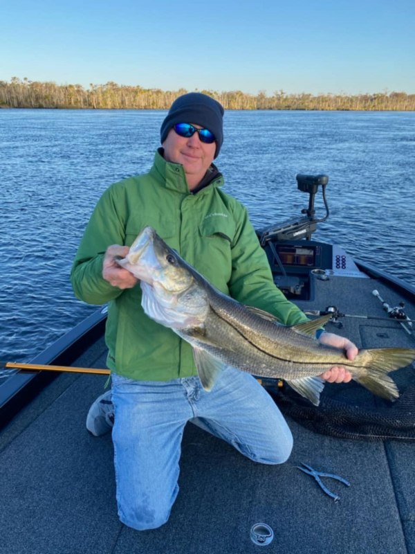 An angler holds aloft a fish caught on the Suwannee River in Florida.