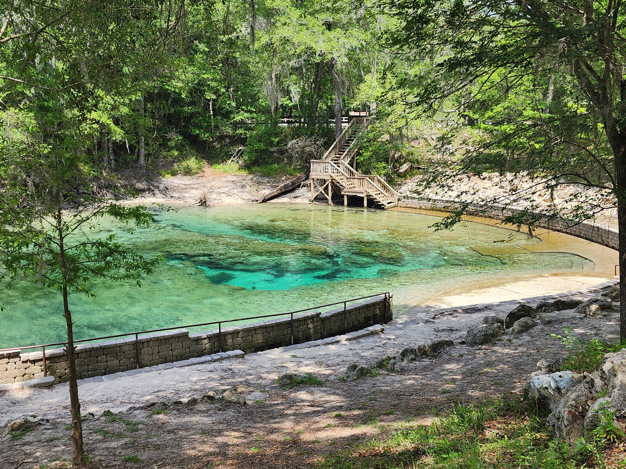 Clear water shows the shallow entrance and underwater rocks at Little River Springs in Suwannee County, Florida. 