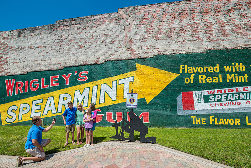 A family poses for a picture in front of the Wrigley's Spearmint Gum mural in Suwannee County, Florida.