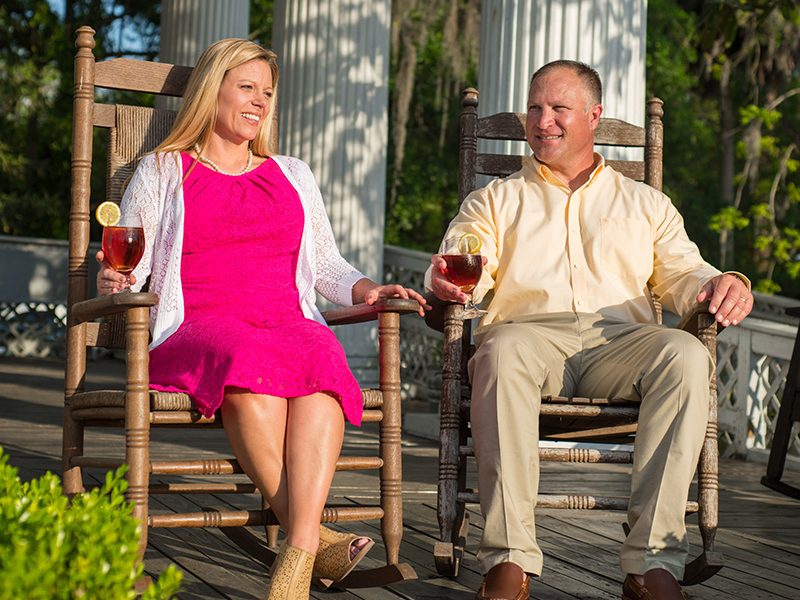 A couple enjoys glasses of iced tea while sitting in rocking chairs at a local restaurant in Suwannee County, Florida.