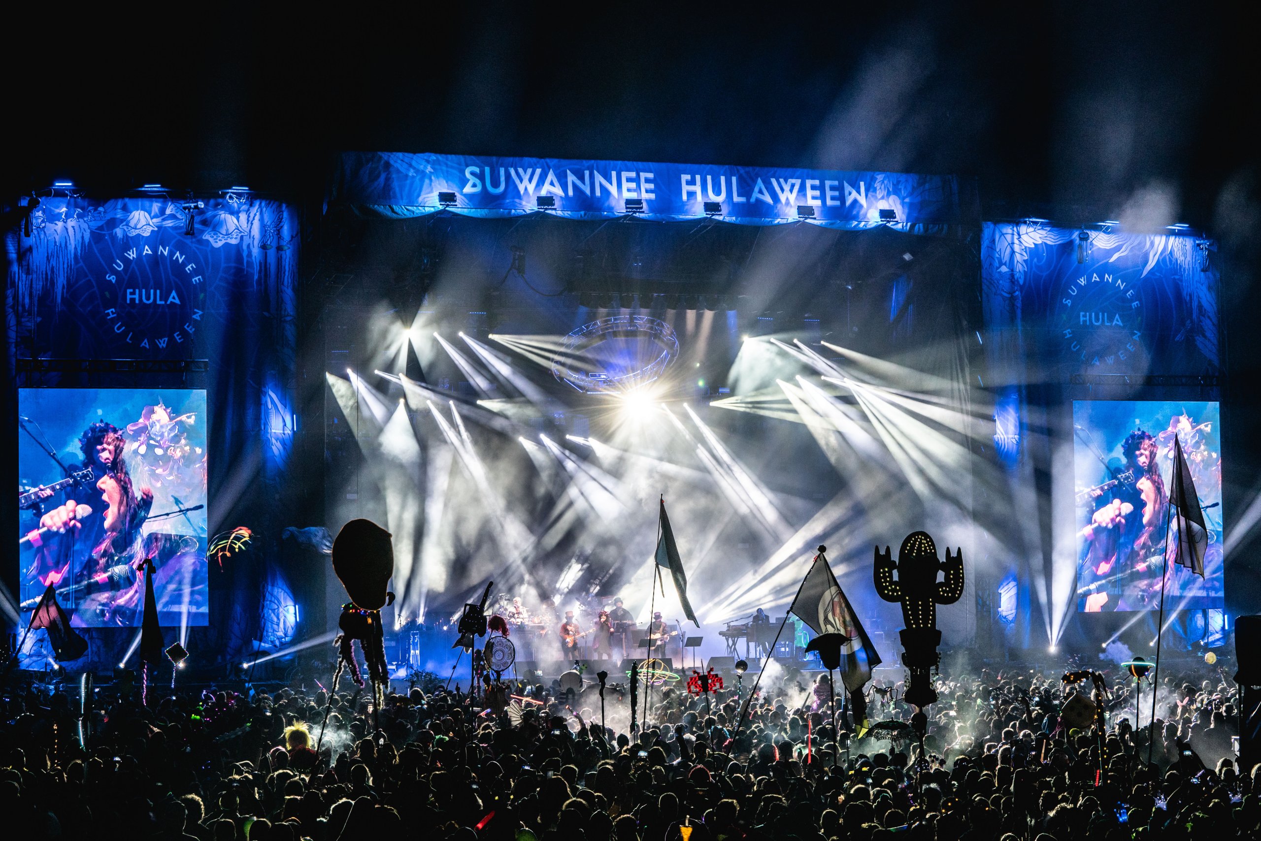 Nighttime festival goers enjoy live music during Suwannee County's Hulaween event in sunny Florida.