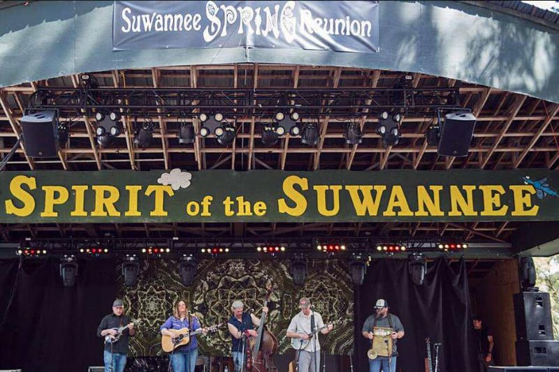 A band of five musicians play on the stage during the Suwannee Spring Reunion event at the Sprit of the Suwannee Park in Suwannee County, Florida.